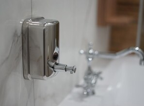A modern bathroom with a wall-mounted soap dispenser and a visible sink. - Apartments Ro Ma (Pozega)