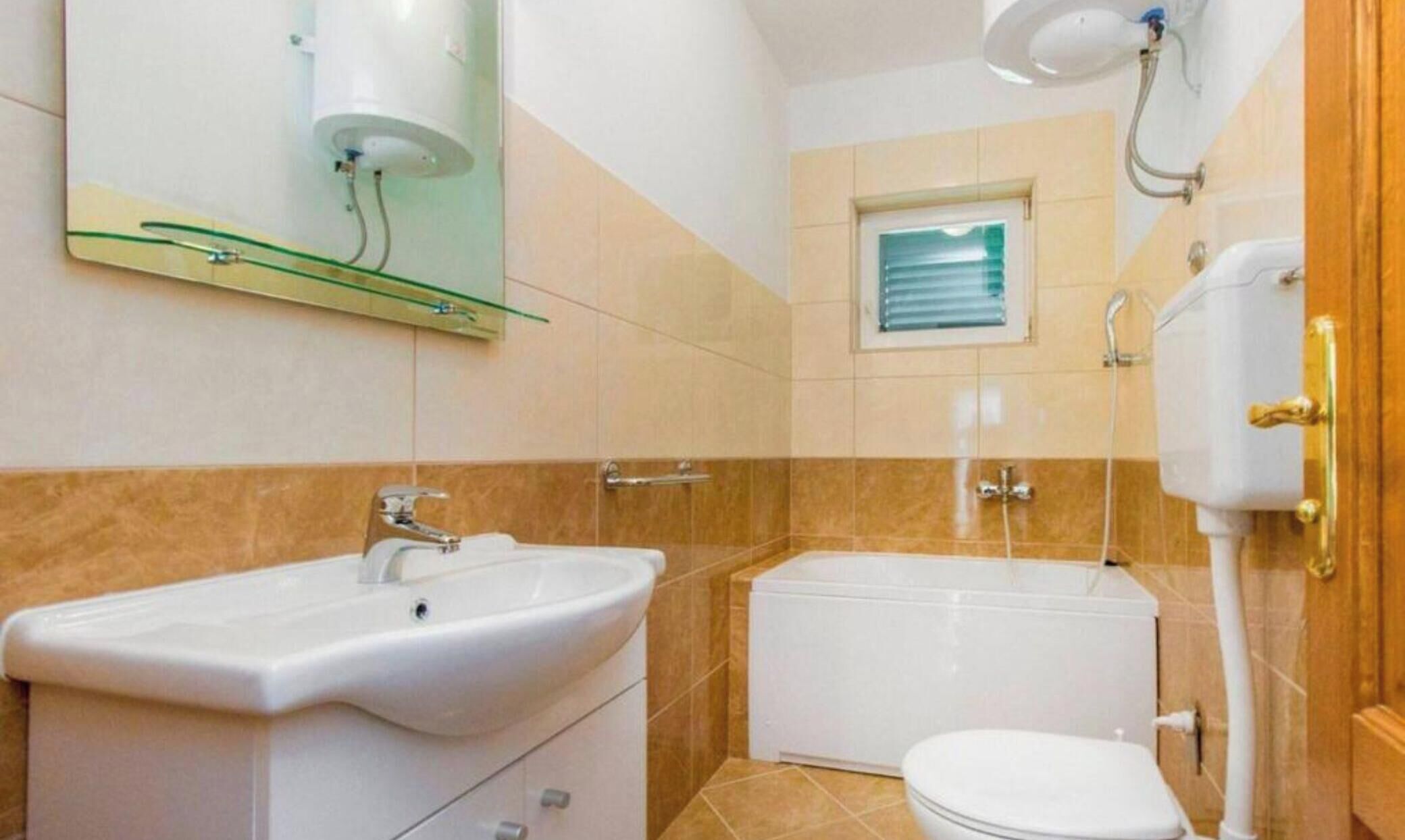 A bathroom with a sink, toilet, and shower.
