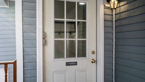 A white door with a glass panel and a nameplate reading "Aspatria." - Cozy Condo in Downtown Ludlow | Walk to Dining (Ludlow)
