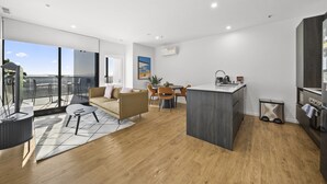 A modern apartment with a balcony, a dining area, and a kitchen.