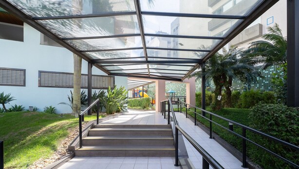 A covered outdoor staircase leading to a building with a playground visible in the background. - 2 Bed. Apt 300 m From the Beira-mar Norte Evp0214 (Florianópolis)