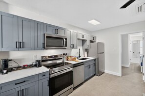 Fridge, microwave, oven, stovetop - 🌅 Steps to Madeira Beach Modern 1BR w/ Courtyard & Grill🌴 (Madeira Beach)