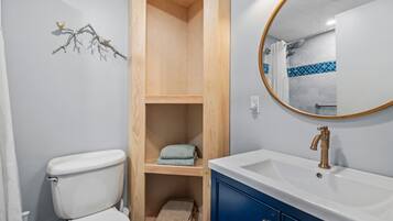 Shower, hair dryer, towels, toilet paper