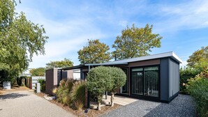 A modern two-story house with a gravel driveway and a small garden area. - Modern Chalet Near Beach in Renesse (Renesse)