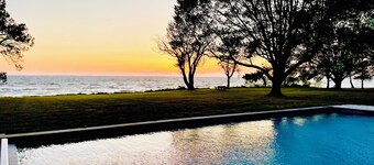 A stunning Chesapeake Bay sunset from a beautiful home with an inground pool!!