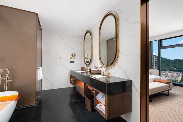 A modern bathroom with a dual sink vanity, marble walls, and a large mirror. - Wyndham Grand Plaza Royale Milky Way Jiande (Hangzhou)