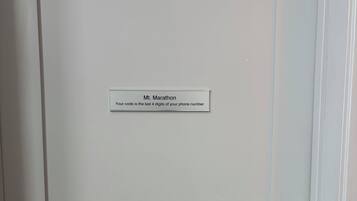 A white door with a label that reads "Mt. Marathon Your code is the last 4 digits of your phone number."