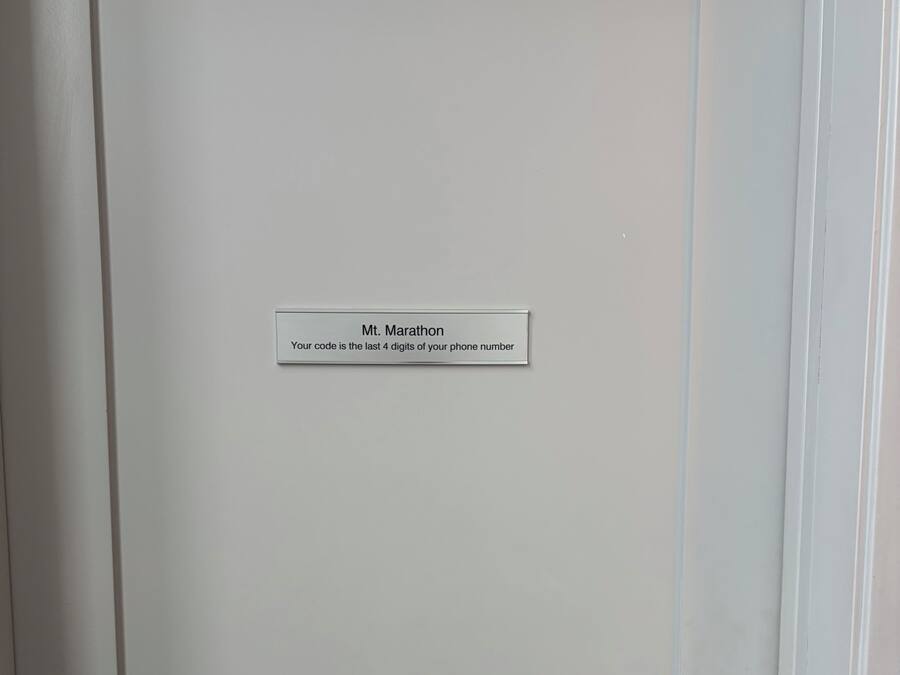 A white door with a label that reads "Mt. Marathon Your code is the last 4 digits of your phone number."