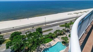 A high-rise hotel with a view of a beach and a swimming pool. - The Cobalt View (Gulfport)