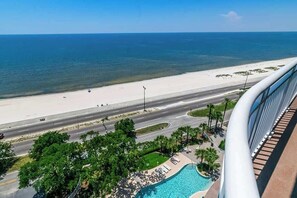 A view of a beach, a swimming pool, and a road. - Spacious Beach View, End Unit in Legacy Tower 2-1301 - 3 Bedroom 3 Bath Condo (Gulfport)