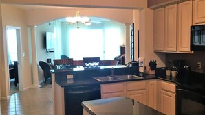 A spacious kitchen with a central island, a microwave, and a dishwasher.