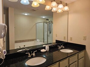 A bathroom with two sinks, a large mirror, and a shower. - Beachview Condo at Legacy Tower 2 -708 - Fully Furnished 2 Bedroom 2 Bathroom (Gulfport)