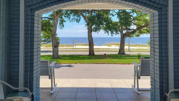 A covered patio with a view of the beach and ocean. - Cypress Cove 103 - Beautiful 1 Bedroom 1 Bath Beachfront Condo in Biloxi (Biloxi)