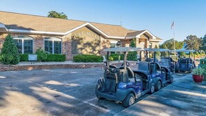 A golf club building with a sign reading "Gulf Hills Golf Club". - Brand New, Fully Furnished 3 Bedroom, 3 Bathroom Home in Ocean Springs! (Ocean Springs)
