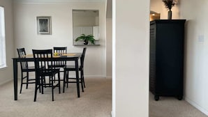 Un coin repas comprenant une table et des chaises, un meuble et une plante fixée au mur.