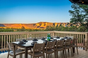 An outdoor dining area with a view of a mountainous landscape.