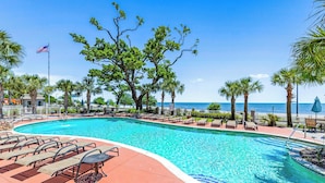 A pool area with lounge chairs and a view of the ocean. - Beachview Condo at Legacy Tower 2 -1103 - Fully Furnished 2 Bedroom 2 Bath (Gulfport)