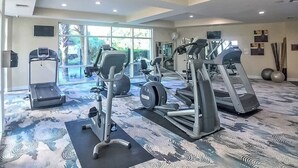 A gym with treadmills, elliptical machines, and weight stations. - Beachview Condo in Legacy Tower1 -303 - With Reserved Parking Spot in Front (Gulfport)