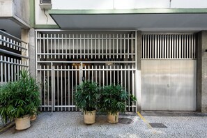 A gated entrance with metal bars, potted plants, and a closed metal door. - 800M Da Praia De Copacabana | Bc101 (Rio de Janeiro)