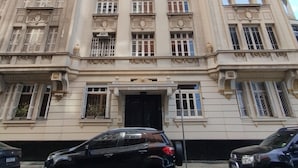 A large, historic building with a grand entrance and multiple windows. - Vista Para O Mar 50 Metros Da Praia | Bi701 (Rio de Janeiro)