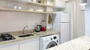 A modern kitchen with a built-in washing machine, a refrigerator, and a coffee maker. - 6 Minutos Da Praia De Copacabana | Br1033 (Rio de Janeiro)