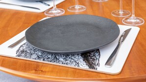 A dining table with a black plate, silverware, and multiple wine glasses. - 5 Minutos Da Praia E Vista Para O Cristo | Br904 (Rio de Janeiro)