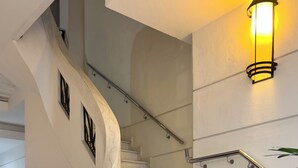 A modern staircase with a handrail, a wall-mounted light fixture, and a black object on the left. - 2 Minutos Da Praia De Copacabana | Df408 (Rio de Janeiro)