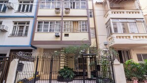 A multi-story residential building with a gated entrance, air conditioning units, and potted plants. - 14 Minutos Da Praia De Copacabana | Fo801 (Rio de Janeiro)