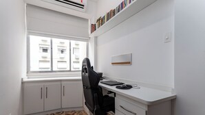 A small, modern office space with a desk, chair, and a window with blinds. - 3 Minutos Da Praia Do Leme | Gs501 (Rio de Janeiro)