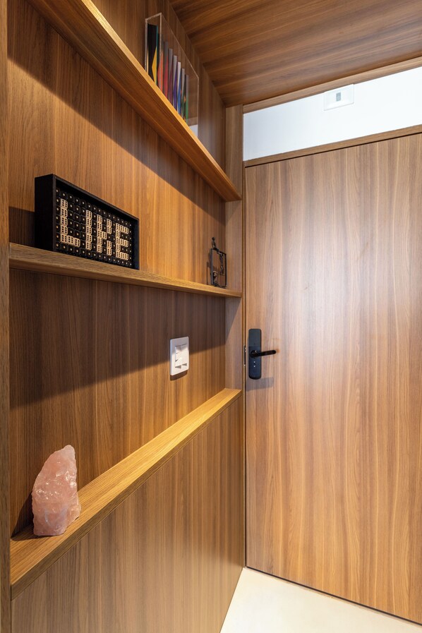 A wooden door with a digital sign that reads "LIKE" and a small crystal on a shelf.