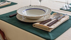 A dining table set with plates, glasses, and cutlery, with a map on the wall behind. - Para Famílias 3Min Da Praia De Copacabana | Sl501 (Rio de Janeiro)