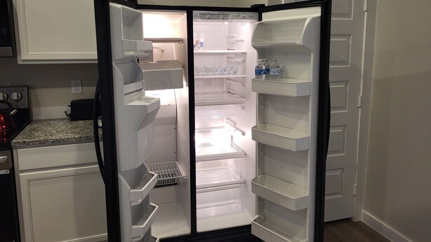 A kitchen with a built-in refrigerator, a microwave, and a toaster.