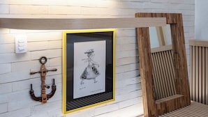 A modern interior with exposed brick walls, wooden beams, and a framed artwork. - Perfeito Para Casais Em Ipanema | Vp802 (Rio de Janeiro)