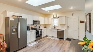 A modern kitchen with white cabinets, stainless steel appliances, and skylights. - Walk to Historic Chestertown: Dog-Friendly Retreat (Chestertown)