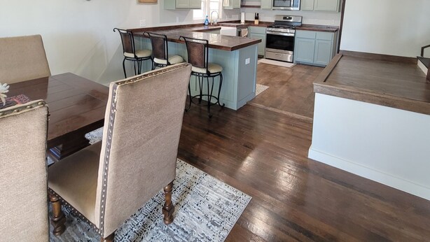 A spacious kitchen with wooden beams, a dining area with a table and chairs, and a cross on the wall. - 511 Western Casa, Where Timeless Western Aesthetics meets Modern Comfort (Marlow)