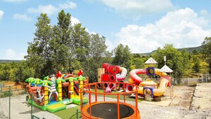 A playground with various play structures including slides, tunnels, and a climbing area. - Lovely home in Grospierres with WiFi (Grospierres)
