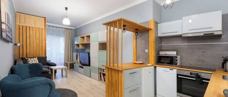 A compact living space with a kitchenette, a dining area, and a seating area.