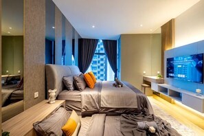 A modern hotel room with a large bed, a TV, and a view of the city. - EATON BY FEEL HOME (Kuala Lumpur)