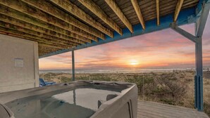 A hot tub with a view of the ocean at sunset. - Serenity at South Beach (Westport)