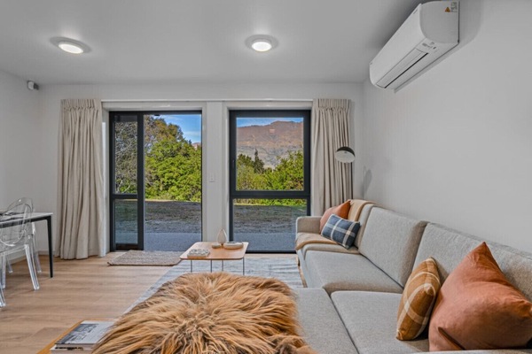 Living Room: Stunning views await from this stylish retreat with chic decor and inviting light!