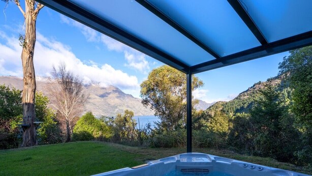 A hot tub with a view of mountains and a lake. - Arawata Alpine Views - 2BDRM luxury (Queenstown)