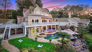 A two-story house with a pool, outdoor seating, and a covered patio. - Lake Norman Retreat w/ Pool, Hot Tub & Private Dock Lake Life Cove by Avantstay (Mooresville)