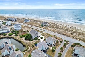 An aerial view of a coastal residential area with houses, a beach, and a body of water. - Escape to Sandy Dreams, a beautifully remodeled villa perfectly situated on Bald Head Island. (Bald Head Island)