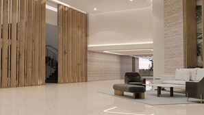 A spacious lobby with a modern design, featuring a wooden partition, a sofa, and a coffee table. - Blueground | DIFC, rooftop pool, nr Burj Khalifa (Dubai)