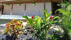 A multi-story building with a wooden balcony structure and a covered outdoor area. - Brisas del Mar Bocas (Bastimentos)
