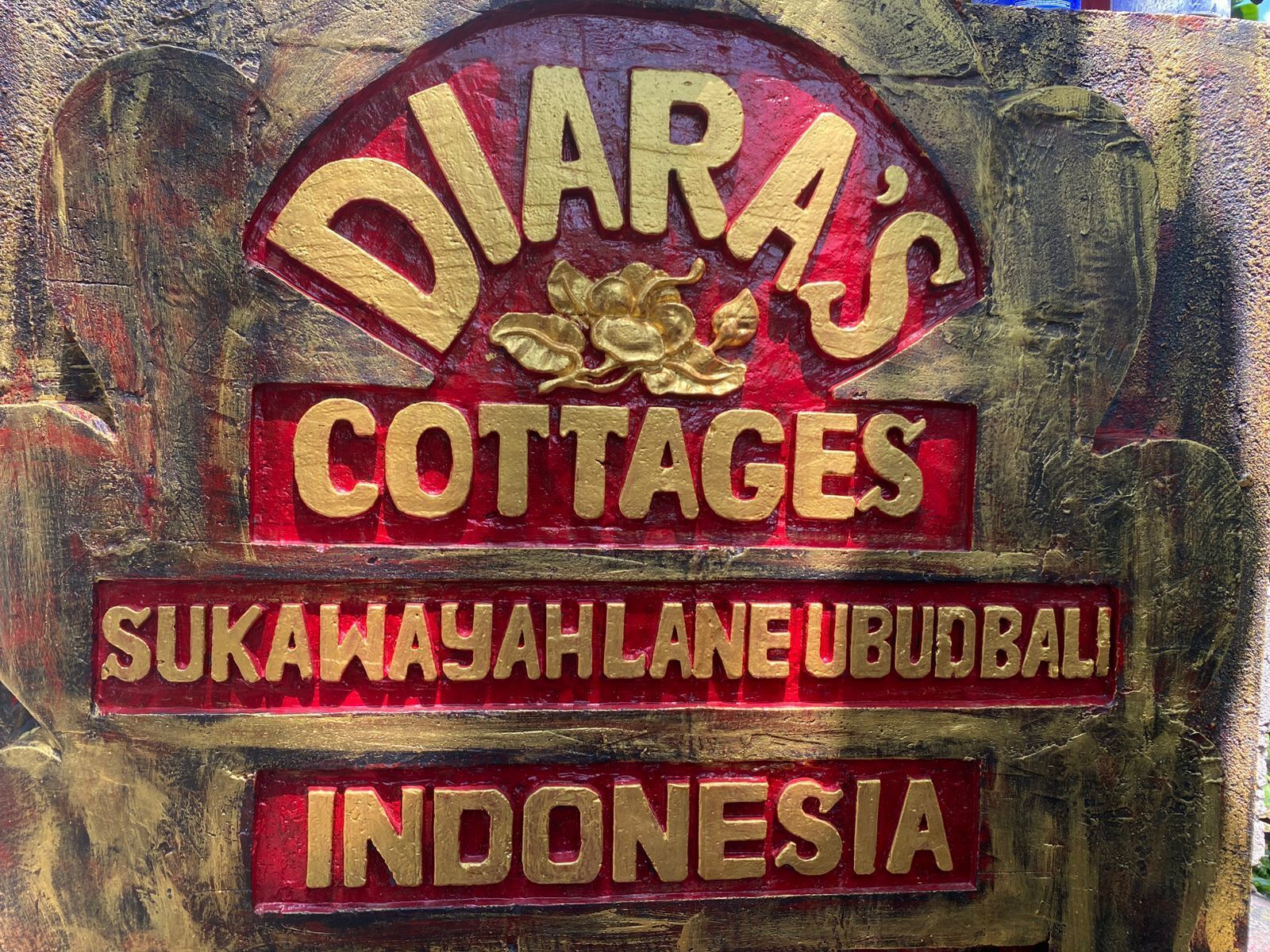 A sign for Diara's Cottages with the address Sukawahyah Lane, Ubud Bali, Indonesia.