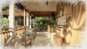 A covered outdoor seating area with wooden furniture and a decorative wall. - The Beach resort (Ko Pha-ngan)