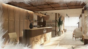 A reception area with a wooden counter, a vase with branches, and a large potted plant. - The Beach resort (Ko Pha-ngan)