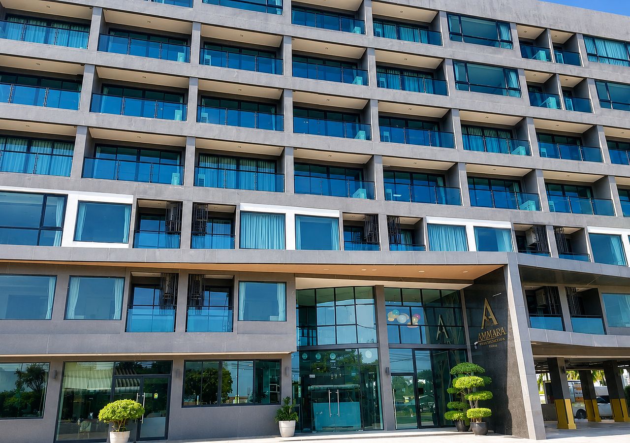 A multi-story hotel with a modern architectural design, featuring a large glass facade and a prominent entrance.