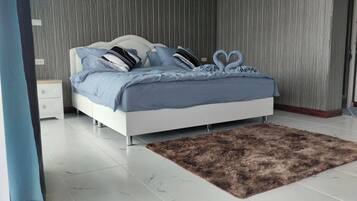 A bedroom with a bed, a nightstand, a fluffy rug, and a wooden wall.